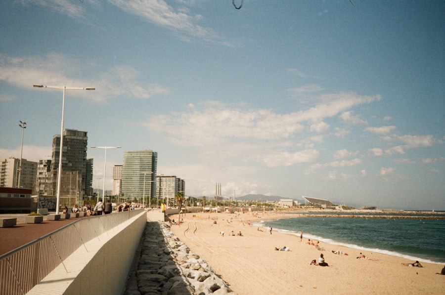 Barcelona's beachfront promenade with the city skyline behind it